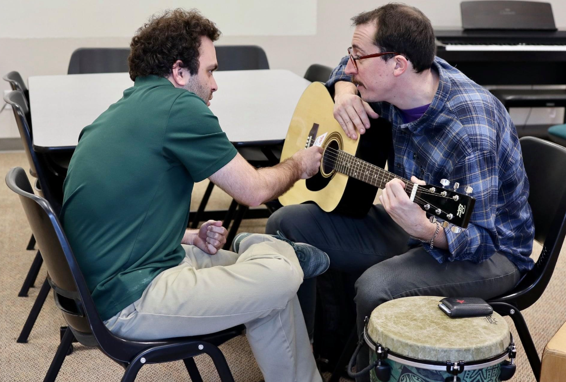 A photo of Maximo and a young adult working in an individual session.